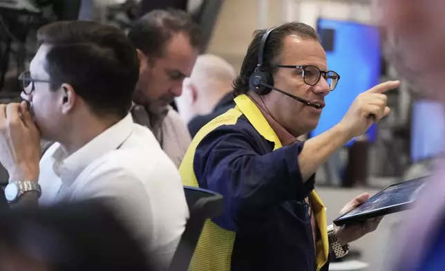 Options trader Anthony Spina, right, works on the floor of the New York Stock Exchange, Monday, Sept. 15, 2025. (AP Photo/Richard Drew)