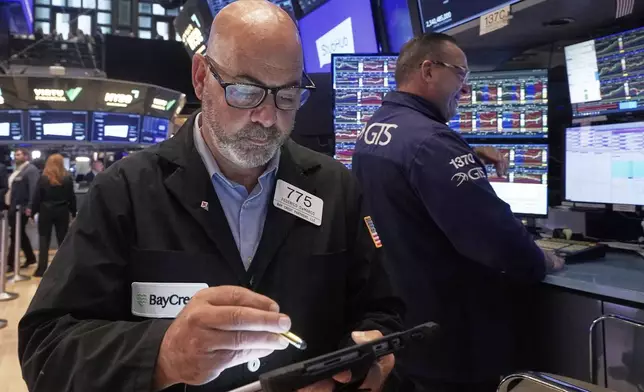 Trader Fred Fred Demarco, left, works on the floor of the New York Stock Exchange, Wednesday, Sept. 17, 2025. (AP Photo/Richard Drew)