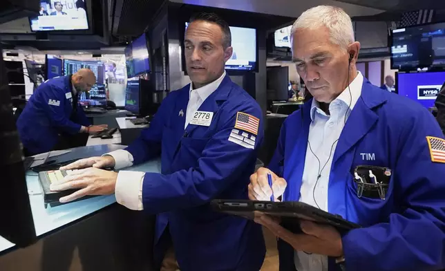 Specialist Michael Gagliano, left, and trader Timothy Nick work on the floor of the New York Stock Exchange, Wednesday, Sept. 17, 2025. (AP Photo/Richard Drew)