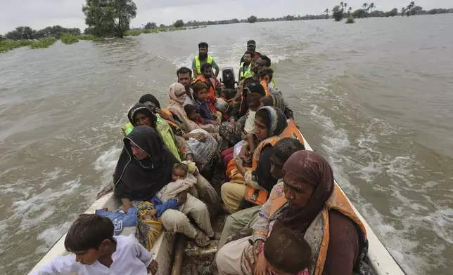 Rescue workers evacuate villagers from a flooded area following raising water level in rivers, in Jalalpur Pirwala, in Multan district, Pakistan, Monday, Sept. 8, 2025. (AP Photo/Asim Tanveer)