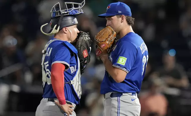 Toronto Blue Jays pitcher Trey Yesavage talks to catcher Tyler Heineman, left, during the first inning of a baseball game against the Tampa Bay Rays Monday, Sept. 15, 2025, in Tampa, Fla. (AP Photo/Chris O'Meara)