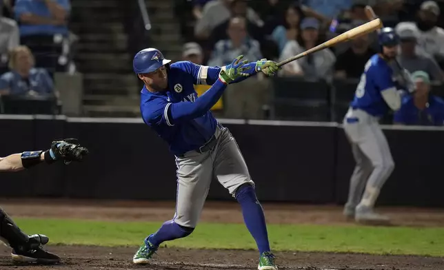 Toronto Blue Jays' George Springer hits an RBI single off Tampa Bay Rays pitcher Kevin Kelly during the 11th inning of a baseball game Monday, Sept. 15, 2025, in Tampa, Fla. (AP Photo/Chris O'Meara)