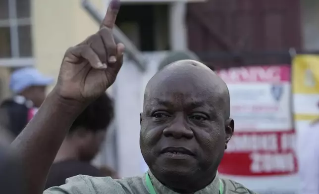 Opposition presidential candidate Aubrey Norton of the A Partnership for National Unity (APNU) coalition shows his ink-stained finger after voting during general elections in Georgetown, Guyana, Monday, Sept. 1, 2025. (AP Photo/Matias Delacroix)