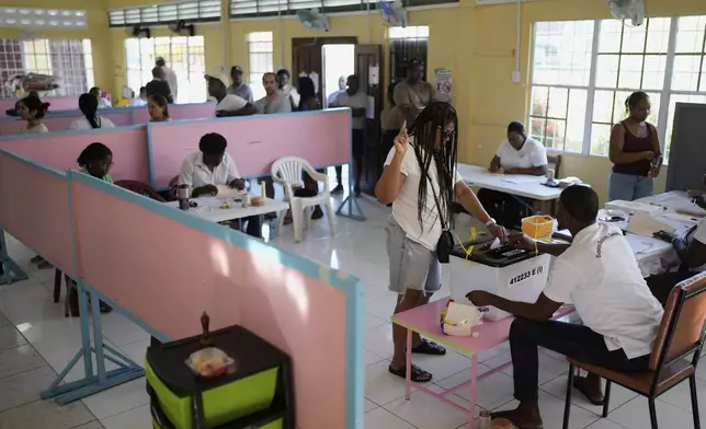 A voter casts her ballot during general elections in Georgetown, Guyana, Monday, Sept. 1, 2025. (AP Photo/Matias Delacroix)