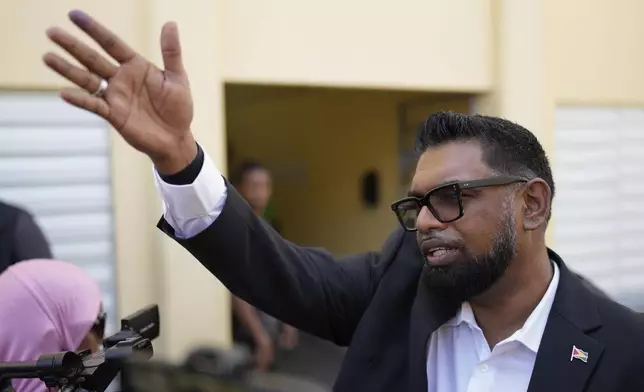 President Irfaan Ali, who is running for re-election, aves after voting during general elections in Leonora, Guyana, Monday, Sept. 1, 2025. (AP Photo/Matias Delacroix)