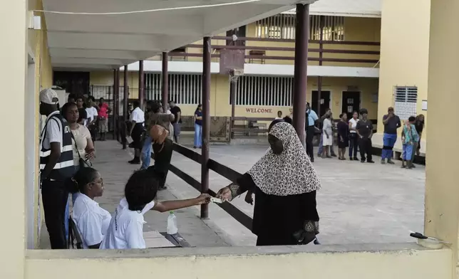 Voters line up at a polling station during general elections in Georgetown, Guyana, Monday, Sept. 1, 2025. (AP Photo/Matias Delacroix)