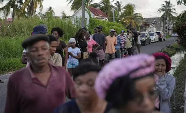 Voters line up at a polling station during general elections in Georgetown, Guyana, Monday, Sept. 1, 2025. (AP Photo/Matias Delacroix)