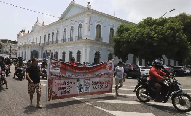 Construction workers building infrastructure for the upcoming COP30 U.N. Climate Summit protest for better pay and working conditions in Belem, Brazil, Sept.18, 2025. (AP Photo/Paulo Santos)