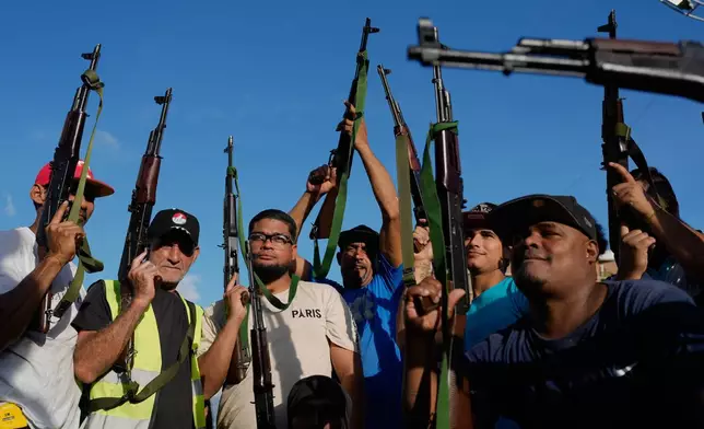 Armed demonstrators march in support of President Nicolas Maduro in Caracas, Venezuela, Tuesday, Sept. 23, 2025. (AP Photo/Ariana Cubillos)