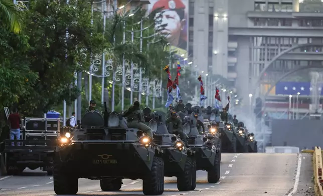 Armored vehicles drive through a street during a government-organized march in support of President Nicolas Maduro in Caracas, Venezuela, Tuesday, Sept. 23, 2025. (AP Photo/Jesus Vargas)