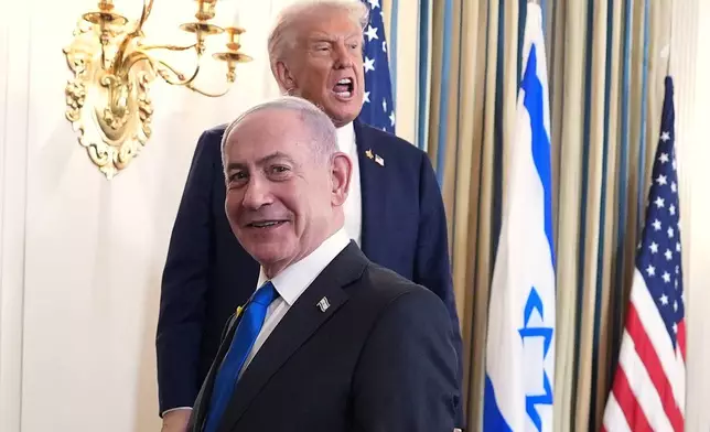 President Donald Trump speaks upon departing a news conference with Israeli Prime Minister Benjamin Netanyahu, in foreground, in the State Dining Room of the White House, Monday, Sept. 29, 2025, in Washington. (AP Photo/Evan Vucci)
