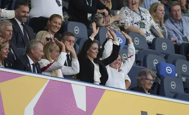 Britain's Kate, Princess of Wales, centre, attends the fan's wave during the Women's Rugby World Cup 2025 Pool A match between England and Australia at the Brighton and Hove Albion Stadium, in Brighton and Hove, England, Saturday, Sept. 6, 2025. (AP Photo/Alastair Grant)