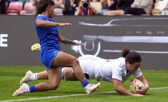 USA's Freda Tafuna, right, scores her sides seventh try of the game during the Women's Rugby World Cup 2025 Pool A match between USA and Samoa in York, England, Saturday, Sept. 6, 2025. (Danny Lawson/PA via AP)