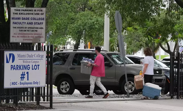 Republican Florida Gov. Ron DeSantis is proposing that President Donald Trump's presidential library be built in a parking lot that is currently used by Miami-Dade College staff and faculty and is adjacent to the Freedom Tower, Tuesday, Sept. 23, 2025, in Miami. (AP Photo/Marta Lavandier)