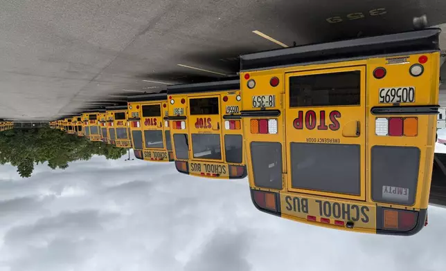 School buses are parked inside the Dayton Public Transportation center on Thursday, August 21, 2025 in Dayton, Ohio. (AP Photo/Patrick Aftoora-Orsagos)