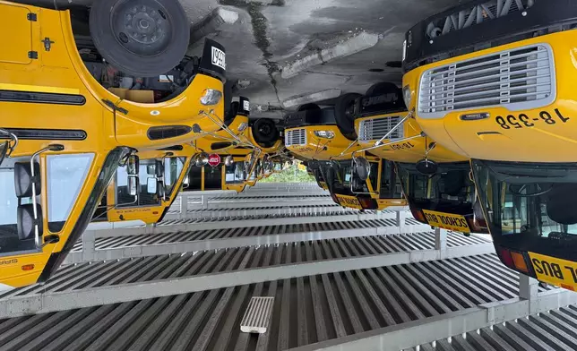 School buses sit inside the Dayton Public Schools Transportation center on Thursday, Aug. 21, 2025 in Dayton, Ohio. (AP Photo/Patrick Aftoora-Orsagos)