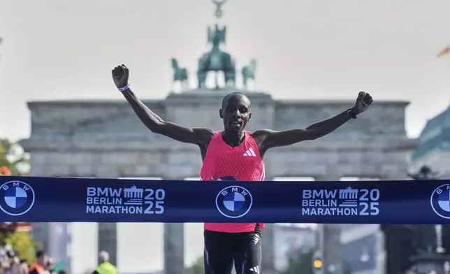 Kenya's Sebastian Sawe crosses the finish line to win the Berlin Marathon in Berlin, Germany, Sunday, Sept.21, 2025. (AP Photo/Markus Schreiber)