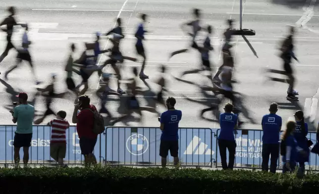 Competitors run in the Berlin Marathon in Berlin, Germany, Sunday, Sept.21, 2025. (AP Photo/Markus Schreiber)
