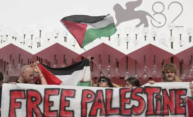 Pro Palestine demonstrators hold a press conference in front of the red carpet to announce a demonstration on Saturday, Aug. 30 during the 82nd edition of the Venice Film Festival in Venice, Italy, on Wednesday, Aug. 27, 2025. (Photo by Alessandra Tarantino/Invision/AP)