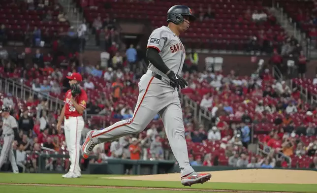 San Francisco Giants' Rafael Devers, right, rounds the bases after hitting a solo home run off St. Louis Cardinals starting pitcher Michael McGreevy, left, during the first inning of a baseball game Friday, Sept. 5, 2025, in St. Louis. (AP Photo/Jeff Roberson)