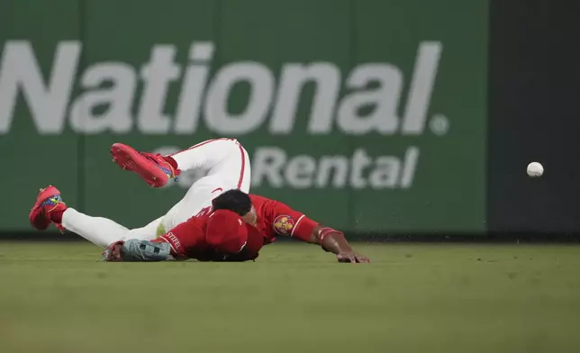 St. Louis Cardinals center fielder Victor Scott II is unable to catch a single by San Francisco Giants' Matt Chapman during the seventh inning of a baseball game Friday, Sept. 5, 2025, in St. Louis. (AP Photo/Jeff Roberson)