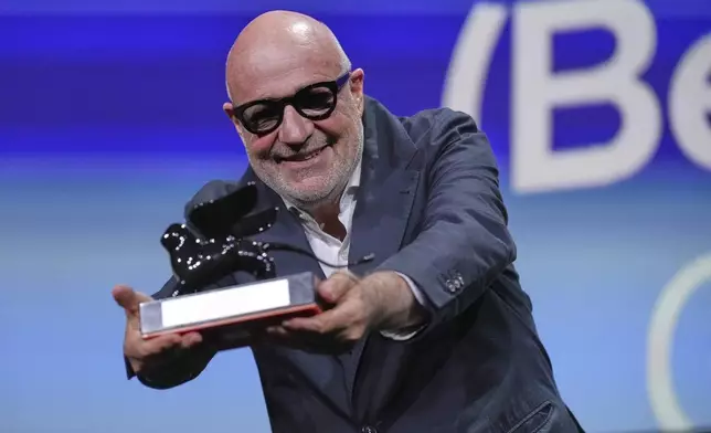 Director Gianfranco Rossi accepts the special jury prize for 'Below the Clouds' during the awards ceremony of the 82nd edition of the Venice Film Festival in Venice, Italy, on Saturday, Sept. 6, 2025. (Photo by Alessandra Tarantino/Invision/AP)