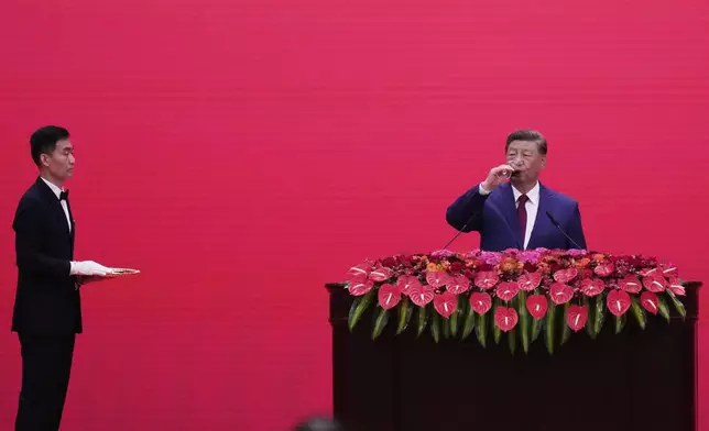 Chinese President Xi Jinping takes a drink at a reception following a military parade to commemorate the 80th anniversary of Japan's World War II surrender held in front of Tiananmen Gate in Beijing, Wednesday, Sept. 3, 2025. (AP Photo/Mahesh Kumar)