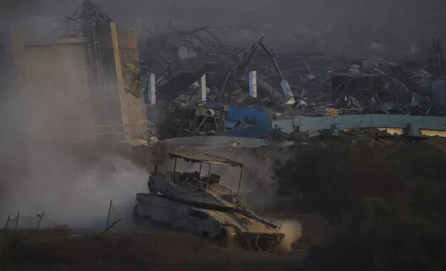 Israeli soldiers drive a tank inside the Gaza Strip as seen from southern Israel, Wednesday, Sept. 3, 2025. (AP Photo/Ariel Schalit)