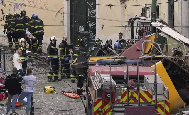 Firefighters carrying the body of a person on a stretcher at the site of a derailed electric streetcar in Lisbon, Portugal, Wednesday, Sept. 3, 2025. (AP Photo/Armando Franca)