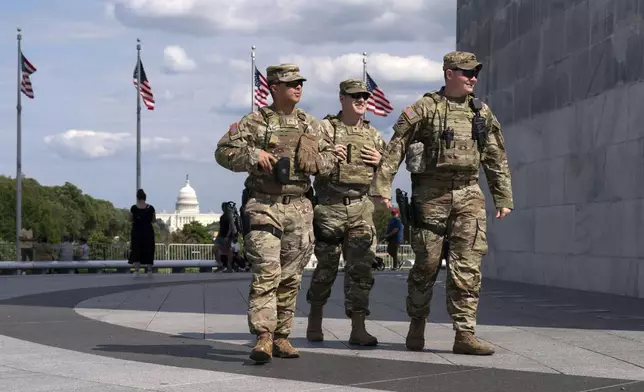 Members of the Louisiana National Guard patrol the grounds of the Washington Monument at the National Mall, Sunday, Sept. 7, 2025, in Washington. (AP Photo/Jose Luis Magana)