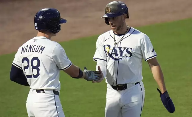 Tampa Bay Rays' Brandon Lowe celebrates with Jake Mangum (28) after owe scored on a fieldeer's choice by Josh Lowe off Seattle Mariners pitcher Bryan Woo during the first inning of a baseball game Tuesday, Sept. 2, 2025, in Tampa, Fla. (AP Photo/Chris O'Meara)