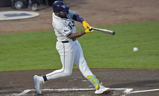 Tampa Bay Rays' Junior Caminero lines an RBI single off Seattle Mariners pitcher Bryan Woo during the first inning of a baseball game Tuesday, Sept. 2, 2025, in Tampa, Fla. (AP Photo/Chris O'Meara)