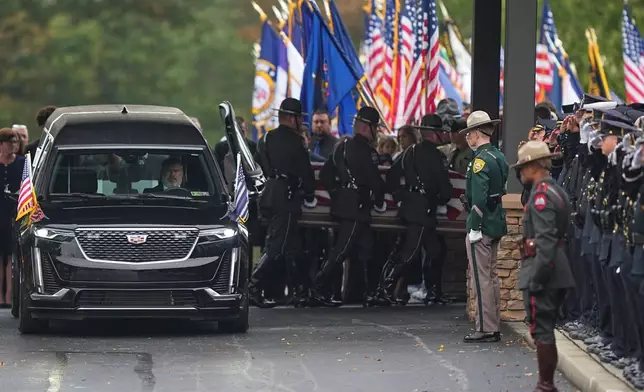 Pall bearers carry the coffin of a slain officer during funeral services for Northern York County Regional Police detectives Cody Michael Becker, Mark Edward Baker and Isaiah Emenheiser, Thursday, Sept. 25, 2025, in Red Lion, Pa. (AP Photo/Matt Rourke)