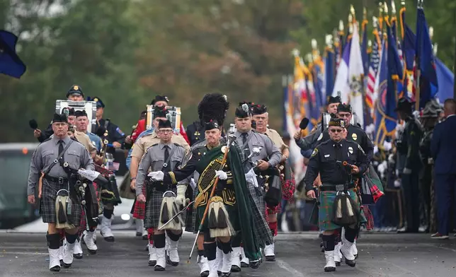 A procession passes for slain Northern York County Regional Police detectives Cody Michael Becker, Mark Edward Baker and Isaiah Emenheiser, Thursday, Sept. 25, 2025, in Red Lion, Pa. (AP Photo/Matt Rourke)