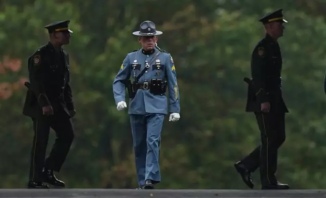 Officers attend funeral services for slain Northern York County Regional Police detectives Cody Michael Becker, Mark Edward Baker and Isaiah Emenheiser, Thursday, Sept. 25, 2025, in Red Lion, Pa. (AP Photo/Matt Rourke)