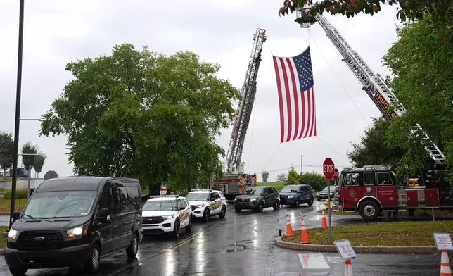 People arrive ahead of funeral services and procession for slain Northern York County Regional Police detectives Cody Michael Becker, Mark Edward Baker and Isaiah Emenheiser, Thursday, Sept. 25, 2025, in Red Lion, Pa. (AP Photo/Matt Rourke)