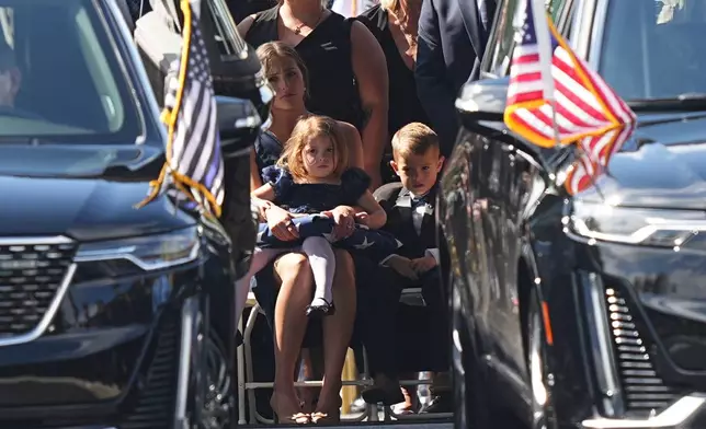 Loved ones look on at the conclusion of funeral services for Northern York County Regional Police detectives Cody Michael Becker, Mark Edward Baker and Isaiah Emenheiser, Thursday, Sept. 25, 2025, in Red Lion, Pa. (AP Photo/Matt Rourke)