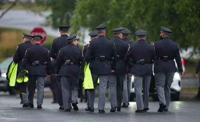 Officers arrive for funeral services of slain Northern York County Regional Police detectives Cody Michael Becker, Mark Edward Baker and Isaiah Emenheiser, Thursday, Sept. 25, 2025, in Red Lion, Pa. (AP Photo/Matt Rourke)