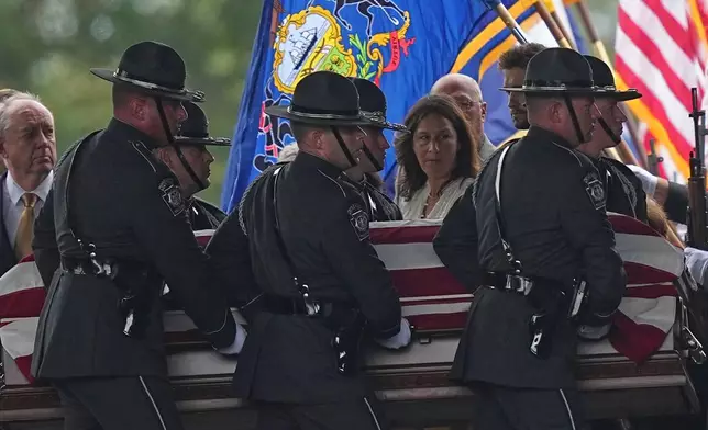 Pall bearers carry the coffin of a slain officer during funeral services for Northern York County Regional Police detectives Cody Michael Becker, Mark Edward Baker and Isaiah Emenheiser, Thursday, Sept. 25, 2025, in Red Lion, Pa. (AP Photo/Matt Rourke)