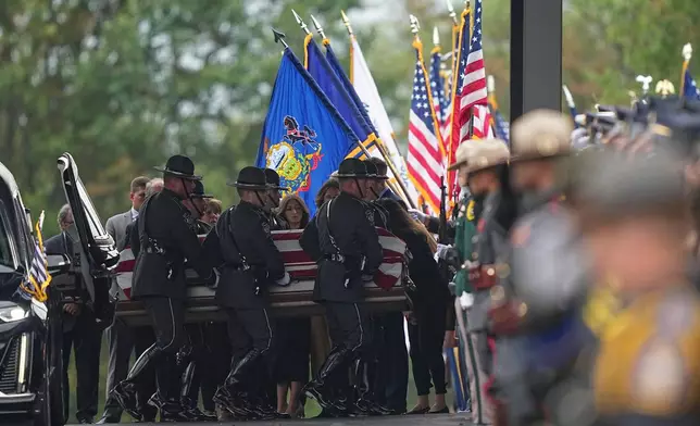 Pall bearers carry the coffin of a slain officer during funeral services for Northern York County Regional Police detectives Cody Michael Becker, Mark Edward Baker and Isaiah Emenheiser, Thursday, Sept. 25, 2025, in Red Lion, Pa. (AP Photo/Matt Rourke)