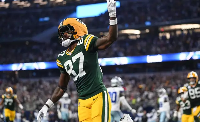 Green Bay Packers wide receiver Romeo Doubs (87) celebrates his touchdown catch in the second half of an NFL football game against the Dallas Cowboys Sunday, Sept. 28, 2025, in Arlington, Texas. (AP Photo/Jessica Tobias)