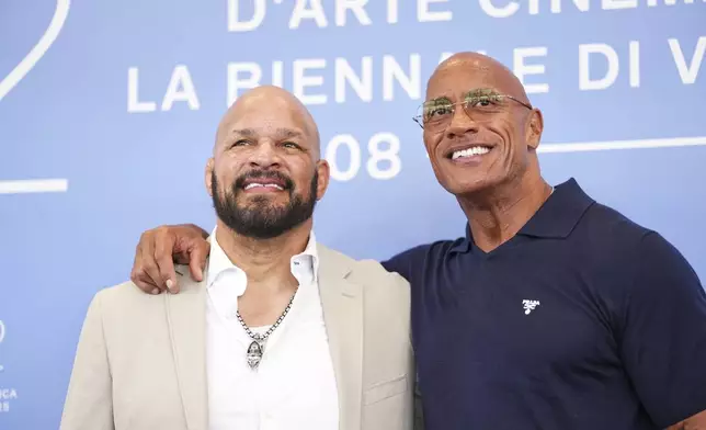 Mark Kerr, left, and Dwayne Johnson pose for photographers at the photo call for the film 'The Smashing Machine' during the 82nd edition of the Venice Film Festival in Venice, Italy, on Monday, Sept. 1, 2025. (Photo by Scott A Garfitt/Invision/AP)