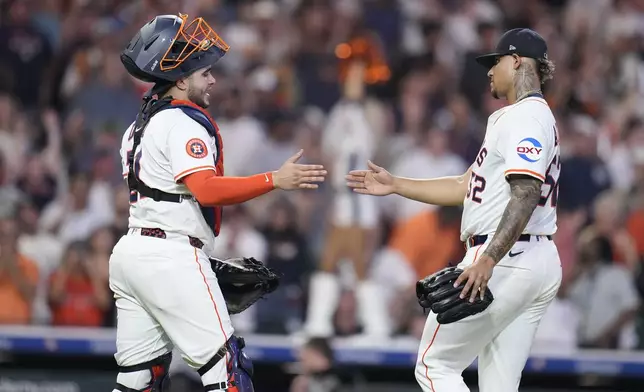 Houston Astros relief pitcher Bryan Abreu, right, celebrates with Houston Astros catcher Yainer Diaz, left, after their win over the New York Yankees during the ninth inning of a baseball game Wednesday, Sept. 3, 2025, in Houston. (AP Photo/Karen Warren)
