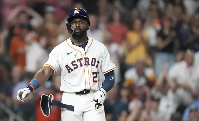 Houston Astros' Taylor Trammell (26) reacts as he was walked by New York Yankees relief pitcher Devin Williams with the bases loaded, scoring a run during the eighth inning of a baseball game Wednesday, Sept. 3, 2025, in Houston. (AP Photo/Karen Warren)