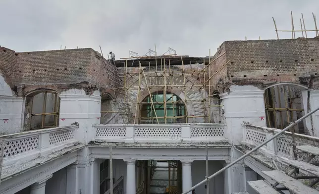 Laborers work at a building in the Mandalay University compound that was damaged in the March 28 earthquake, Mandalay, Myanmar, Wednesday, Aug. 27, 2025. (AP Photo/Aung Shine Oo)