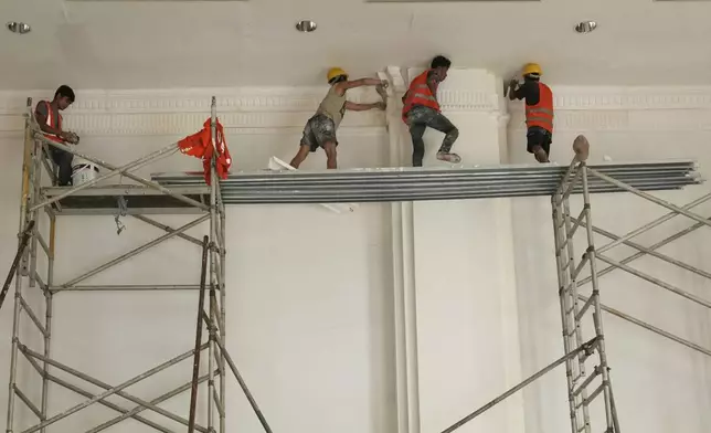 Laborers work inside a parliament building that was damaged in the March 28 earthquake in Naypyitaw, Myanmar, Thursday, Aug. 28, 2025. (AP Photo/Aung Shine Oo)