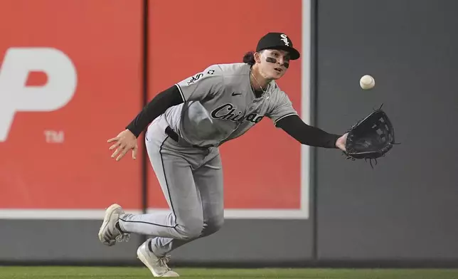 Chicago White Sox right fielder Brooks Baldwin reaches to catch a lineout hit by Minnesota Twins' Luke Keaschall during the first inning of a baseball game Thursday, Sept. 4, 2025, in Minneapolis. (AP Photo/Abbie Parr)