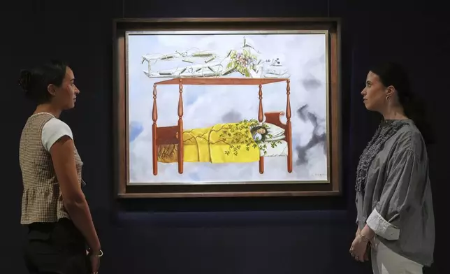 A painting by Frida Kahlo called El sueño (La cama) is displayed at Sotheby's auction rooms, the painting estimated at 40-60 million US dollars is part of a collection of surrealist masterpieces unveiled in London ahead of their sale in New York, Friday, Sept. 19, 2025. (AP Photo/Kirsty Wigglesworth)
