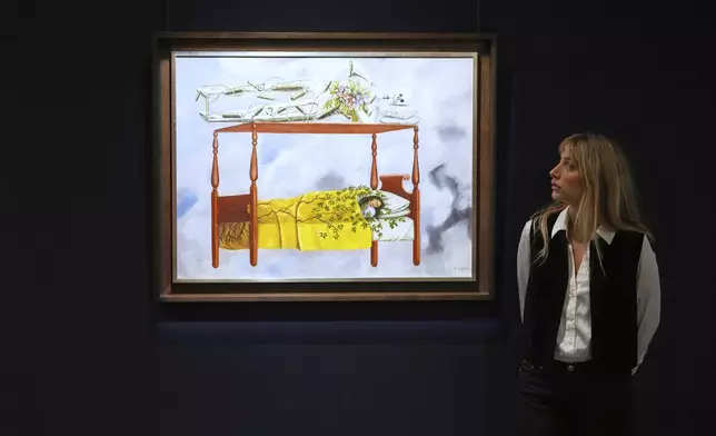 A painting by Frida Kahlo called El sueño (La cama) is displayed at Sotheby's auction rooms, the painting estimated at 40-60 million US dollars is part of a collection of surrealist masterpieces unveiled in London ahead of their sale in New York, Friday, Sept. 19, 2025. (AP Photo/Kirsty Wigglesworth)
