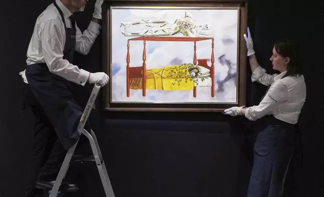 A painting by Frida Kahlo called El sueño (La cama) is displayed at Sotheby's auction rooms, the painting estimated at 40-60 million US dollars is part of a collection of surrealist masterpieces unveiled in London ahead of their sale in New York, Friday, Sept. 19, 2025. (AP Photo/Kirsty Wigglesworth)